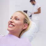 Woman showing her white teeth in clinic