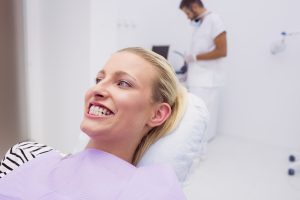 Woman showing her white teeth in clinic