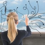 Composite image of blonde businesswoman pointing somewhere